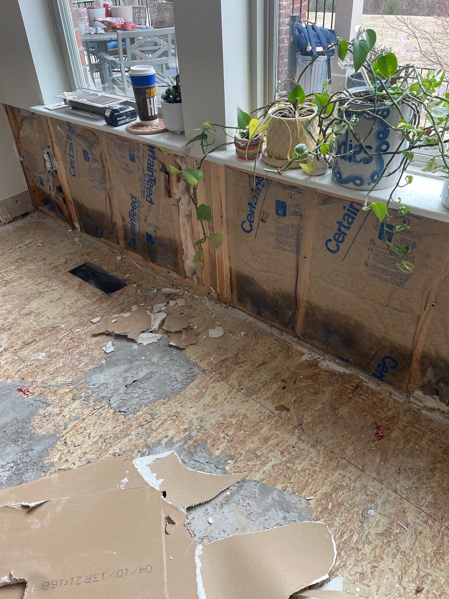 Damaged wall insulation and subfloor after storm damage in Richmond