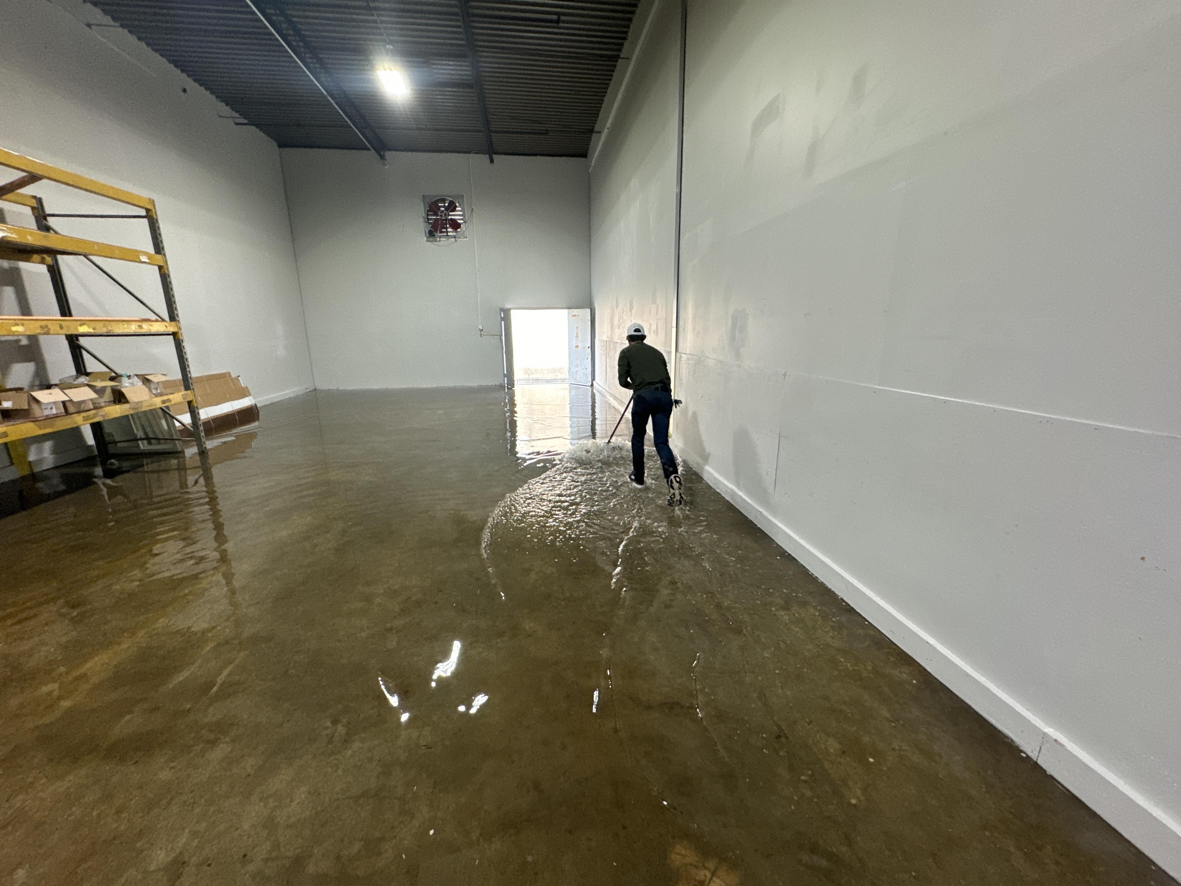 IRS crew member extracting standing water from a Richmond commercial building